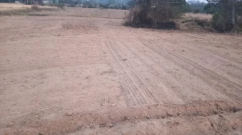 Wide Angle View of Curved Tractor Tire Tracks on Plowed Farmland Stock-Fotos