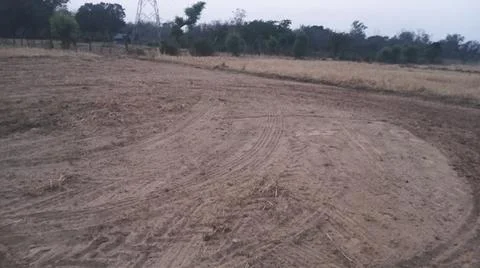 Wide Angle View of Curved Tractor Tire Tracks on Plowed Farmland Fotos de archivo