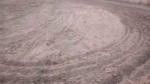 Wide Angle View of Curved Tractor Tire Tracks on Plowed Farmland Stock-Fotos