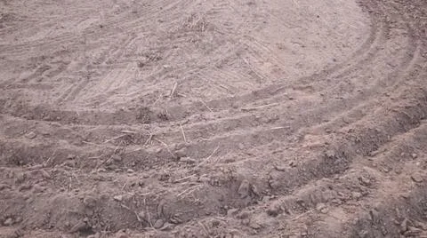 Wide Angle View of Curved Tractor Tire Tracks on Plowed Farmland Stock-Fotos