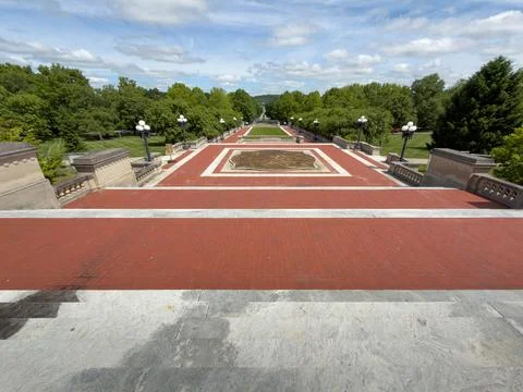 Wide-angle view down the Capitol's marble steps and red brick terrace Stock Photos
