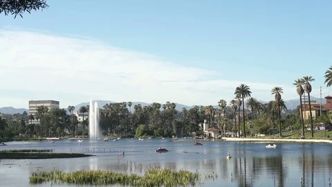 Wide angle view of Echo Park Lake with fountain and people on pedal boat Video stock 75882507