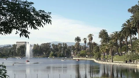 Wide angle view of Echo Park Lake with fountain and people on pedal boat Video stock 75882710