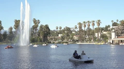 Wide angle view of Echo Park Lake with fountain and people on pedal boat Stock Footage 75943795