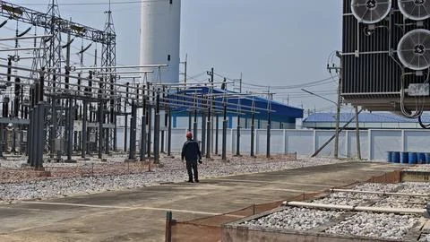 Wide angle view of electrical engineer worker with red helmet inspecting. Stock Photos