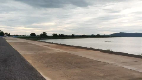 Wide Angle View of Empty Dam Concrete Road Along Reservoir Lake Stock Footage 343775048