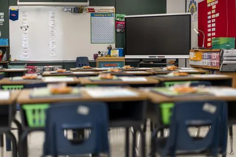 Wide angle view of empty elementary school classroom in the US. Stock Photos