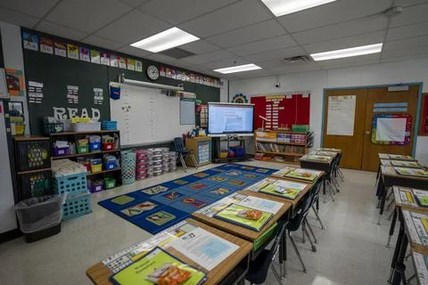 Wide angle view of empty elementary school classroom in the US. Stock Photos