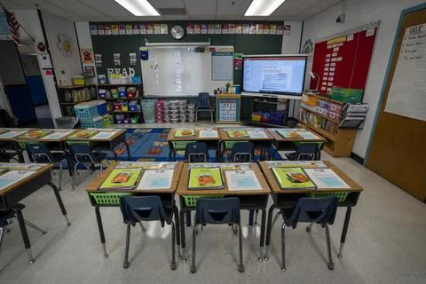 Wide angle view of empty elementary school classroom in the US. Stock Photos