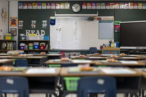 Wide angle view of empty elementary school classroom in the US. Stock Photos