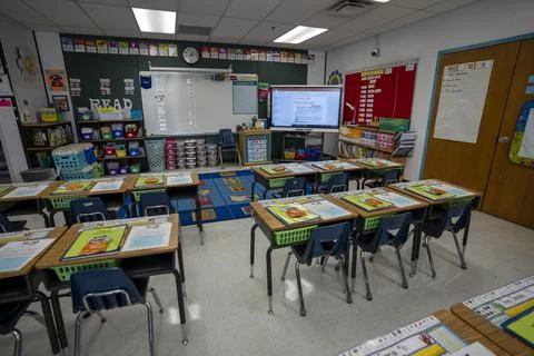 Wide angle view of empty elementary school classroom in the US. Stock Photos