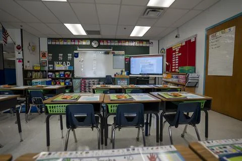 Wide angle view of empty elementary school classroom in the US. Stock Photos