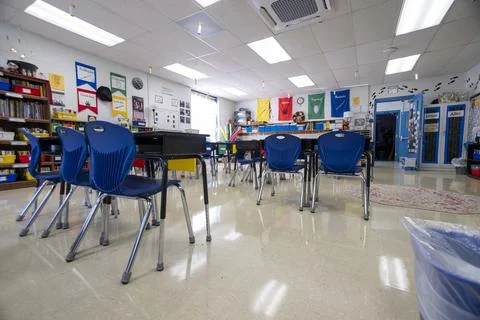 Wide angle view of empty elementary school classroom with interactive whiteboard Stock Photos