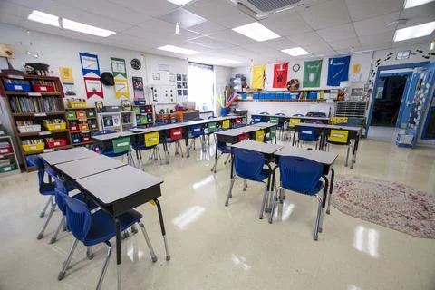 Wide angle view of empty elementary school classroom with interactive whiteboard Stock Photos