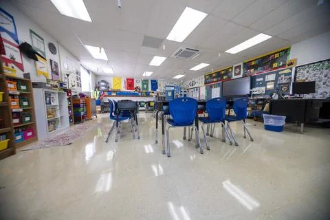 Wide angle view of empty elementary school classroom with interactive whiteboard Stock Photos