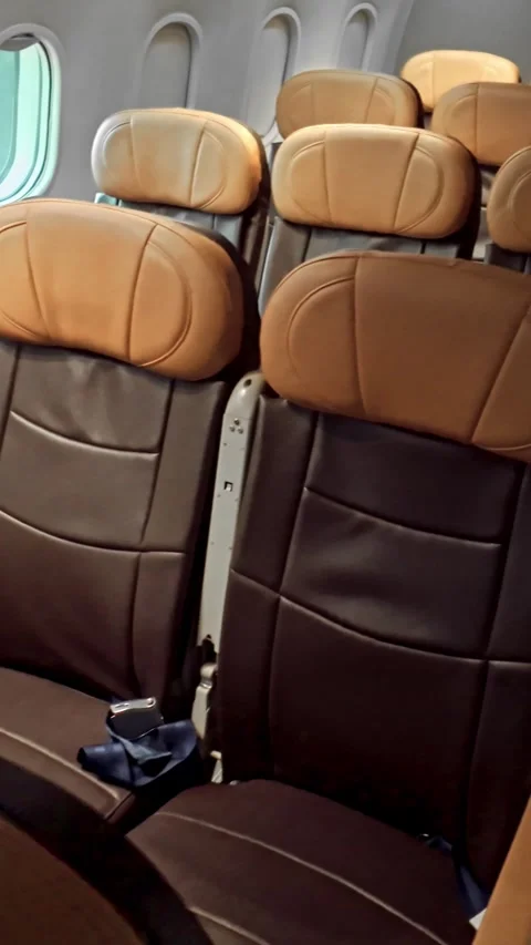 Wide-angle view of an empty modern aircraft cabin with leather seats and ambient Stock Footage 321000177