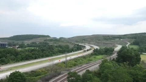 A Wide Angle View of a Four Lane Highway and Railroad Tracks Vidéo 158239936