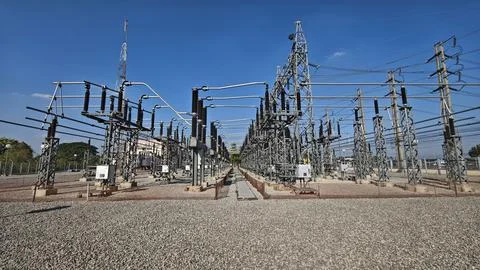 Wide angle view of high voltage electrical power substation switchyard. Stock Photos