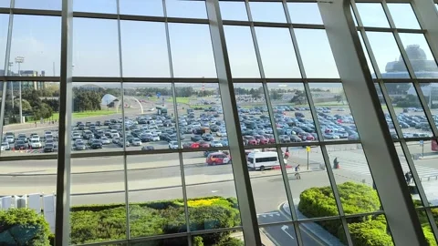 Wide angle view of a huge crowded parking lot through glass windows. Stock-Footage 337359763