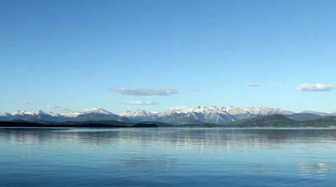 Wide-angle view of ice-covered mountains next to a lake near Bariloche, Argentin Stock Footage 60141958