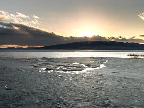 Wide angle view of ice stacks on Utah Lake at sunset. Stock Photos