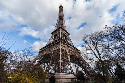 Wide angle view of iconic Eiffel tower with dramatic cloudy blue sky Stock Photos