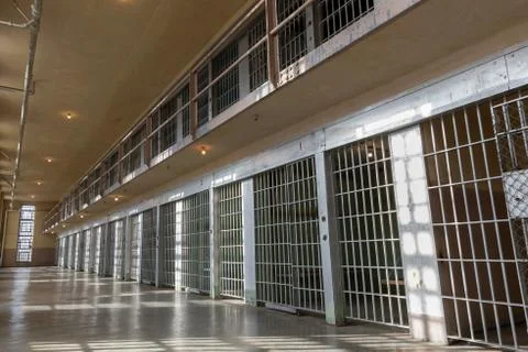 Wide angle view of Jail or prison bars being lit up by the sun Stock Photos