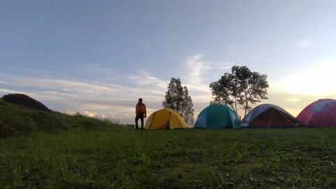 Wide angle view man contemplating alone araound his camping tents at bromo mount Stock Footage 151302535