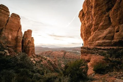 Wide angle view of man watching sunset in Sedona Arizona from Cathedral Roc.. Stock Photos