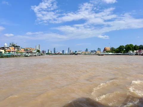 Wide angle view from the middle of Chao Phraya River towards the riverside Stock Photos