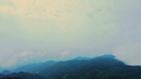 Wide angle view of misty green mountains under a cloudy overcast sky Stock Footage 342241107