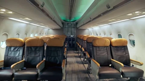 Wide-angle view of a modern airplane cabin with empty leather seats, clean. Stock-Footage 310232848