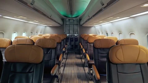 Wide-angle view of a modern airplane cabin with empty leather seats. Stock Footage 310721760