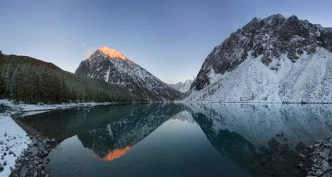 Wide angle view of Montriond Lake on a sunny day, mountains in the background Stock Photos