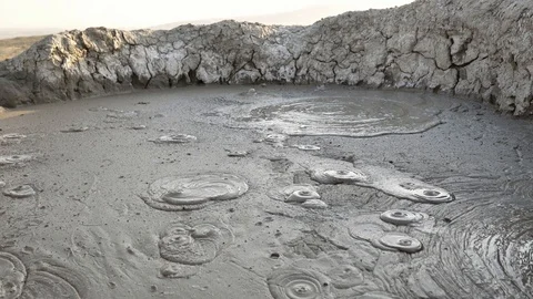 Wide angle view of a mud bubbling in a rock pool at the Mud Volcanoes in Stock Footage 100349297