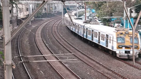 Wide angle view of Mumbai Local Train Honking and Passing by during evening Stock Footage 168757889