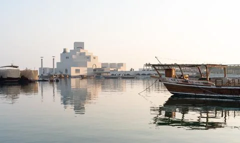 Wide angle view of Museum of Islamic Art and traditional dhow boat at dawn,.. Stockfoto's