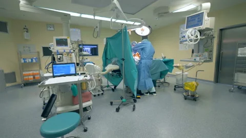 Wide angle view of an operating unit with a surgery being carried out in it Stock Footage 98647929