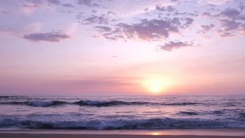 Wide angle view over beach at sunset, parallel to shore. Slow slide right Stock Footage 115920530