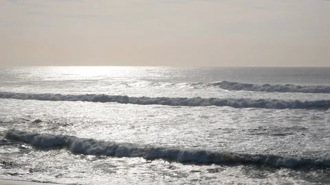 Wide angle view over ocean with sun reflecting on water and fog in distance Stock Footage 103642806