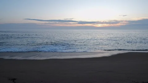 Wide angle view over shoreline on beach at sunset with relaxing wave sounds Stock Footage 116366986