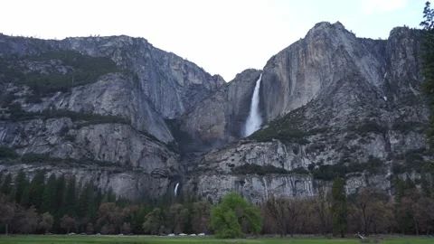 Wide angle view: overflowing Upper and Lower Yosemite Falls from valley Stock Footage 241194124