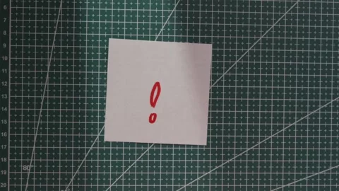 Wide angle view of placing question mark note on green mat Stock Footage 341269442
