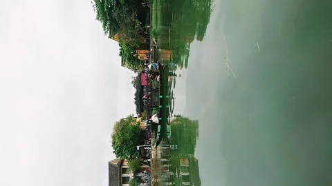 Wide angle view of river life with reflection in Hoi An old town, Vietnam 스톡 동영상 248409125