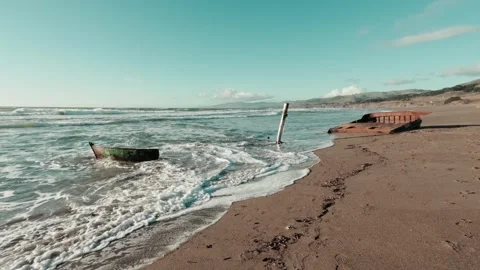 Wide angle view of rusty shipwreck on a beach on a sunny day Stock Footage 301503529
