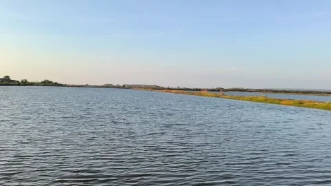 Wide Angle View of Serene Fish Farm Pond and Coastal Wetlands Stock Footage 340489155