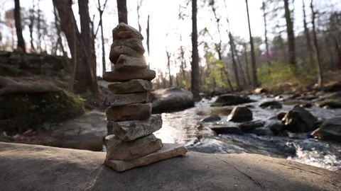 Wide Angle View Of Stacked Rocks Near Slow Motion Flowing River Lens Flare 스톡 동영상 315225368