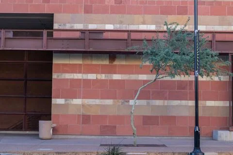 Wide angle view of stone wall with steel beam and grid above Stock Photos