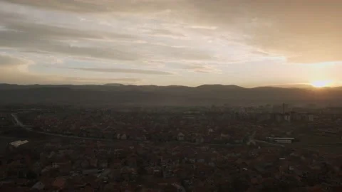 Wide angle view of sunset above the city, while Sun is setting behind mountains Stock Footage