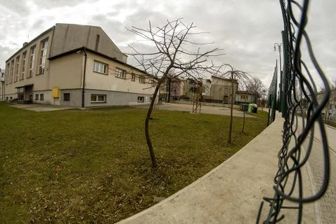 Wide angle view through the broken fence wires of Bunch of a school premises  Stock Photos
